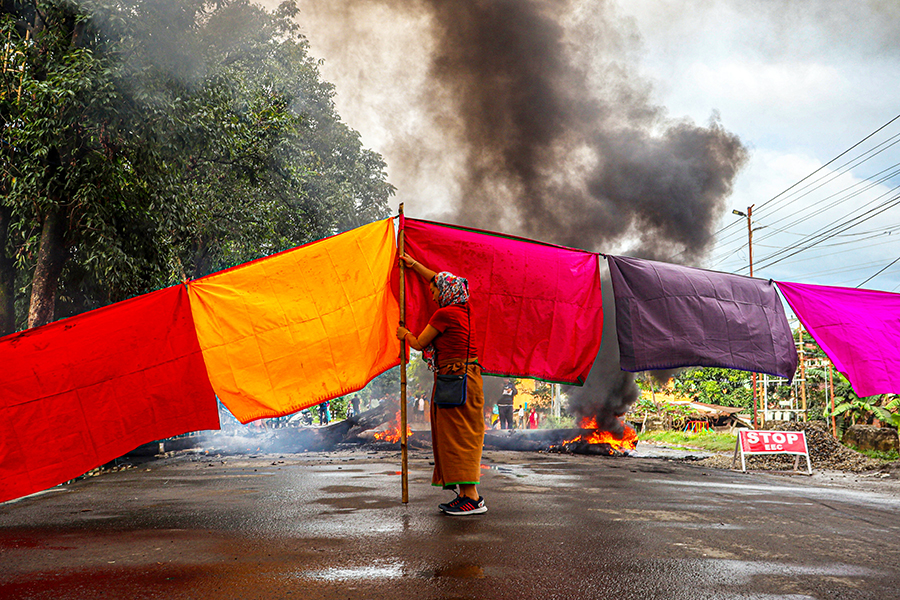 A woman protester blocks a road during a 48-hour general strike in Imphal on September 19, 2023, as they demand restoration of peace in India's northeastern state of Manipur after ethnic violence. Image: AFP

