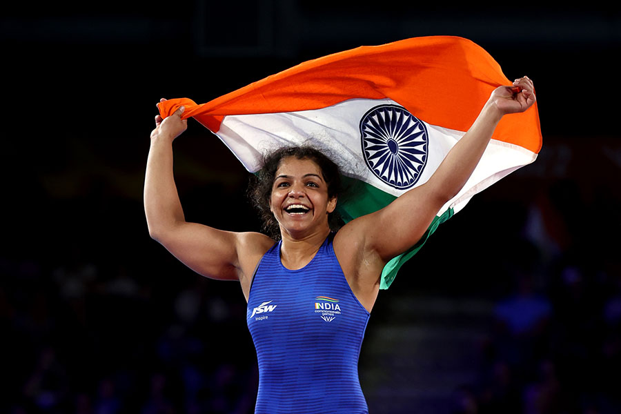 Sakshi Malik of Team India celebrates after defeating Ana Godinez Gonzalez (red) of Team Canada during the Women's Freestyle 62 kg Gold Medal match on day eight of the Birmingham 2022 Commonwealth Games at  on August 05, 2022 on the Coventry, England. Image Credit: Al Bello/Getty Images