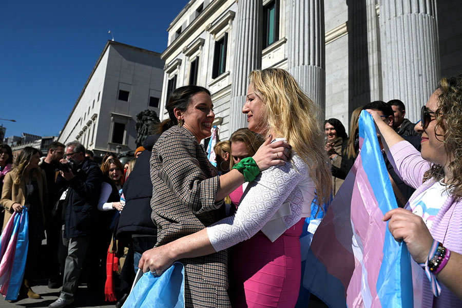 Spain's Minister for Equality Irene Montero (L) celebrates with LGBTI+ member Niurka Gibaja in front of the Spanish Congress, in Madrid. Image: Oscar Del Pozo/AFP

