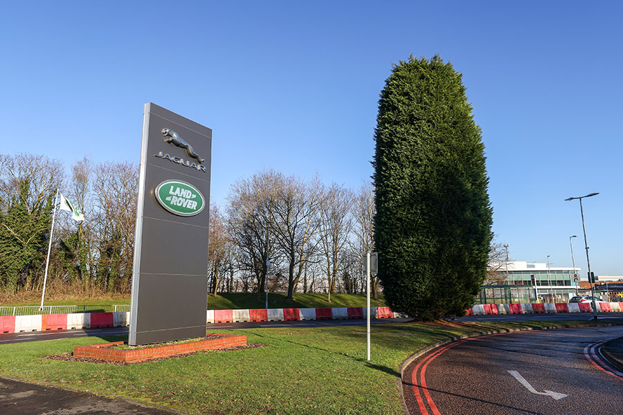 (File photo) A totem displaying company logos at the entrance to Tata Motors Ltd.'s Jaguar Land Rover vehicle manufacturing plant in Solihull, UK, on Friday, January 20, 2023. Image: Chris Ratcliffe/Bloomberg via Getty Images