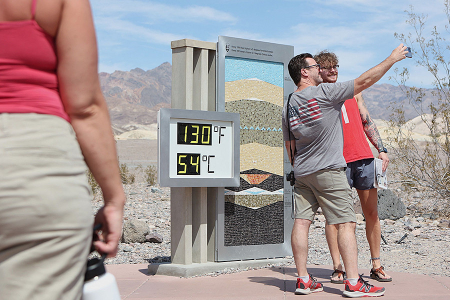 In Death Valley, tourists flock to take pictures of the extreme temperature readings. Image: RONDA CHURCHILL / AFP