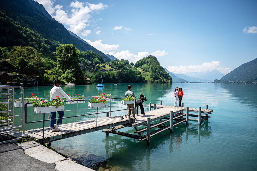 Tourists take a selfie photograph on the famous pier of a South Korean Netflix serie in the village of Iseltwald at the shore of Lake Brienz, in the Swiss Alps.
Image: Fabrice Coffrini / AFP 