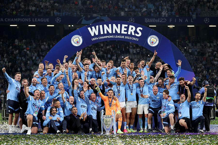Manchester City's players pose with the UEFA Champions League trophy after the team's won the final match against Inter Milan at the Ataturk Olympic Stadium on June 11, 2023 in Istanbul, Turkiye; Image by Berk Ozkan/Anadolu Agency via Getty Images