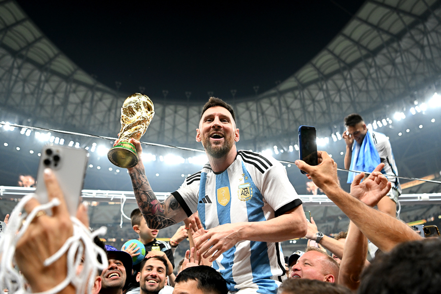 Lionel Messi hoists the FIFA World Cup Trophy after leading his team to victory over France on December 18, 2022 in Lusail City, Qatar