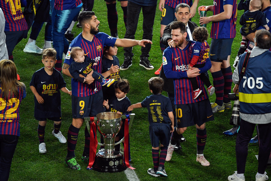 Barcelona's Argentinian forward Lionel Messi and Uruguayan forward Luis Suarez, with their children, celebrate becoming La Liga champions after winning the Spanish League football match between FC Barcelona and Levante UD at the Camp Nou stadium in Barcelona on April 27, 2019