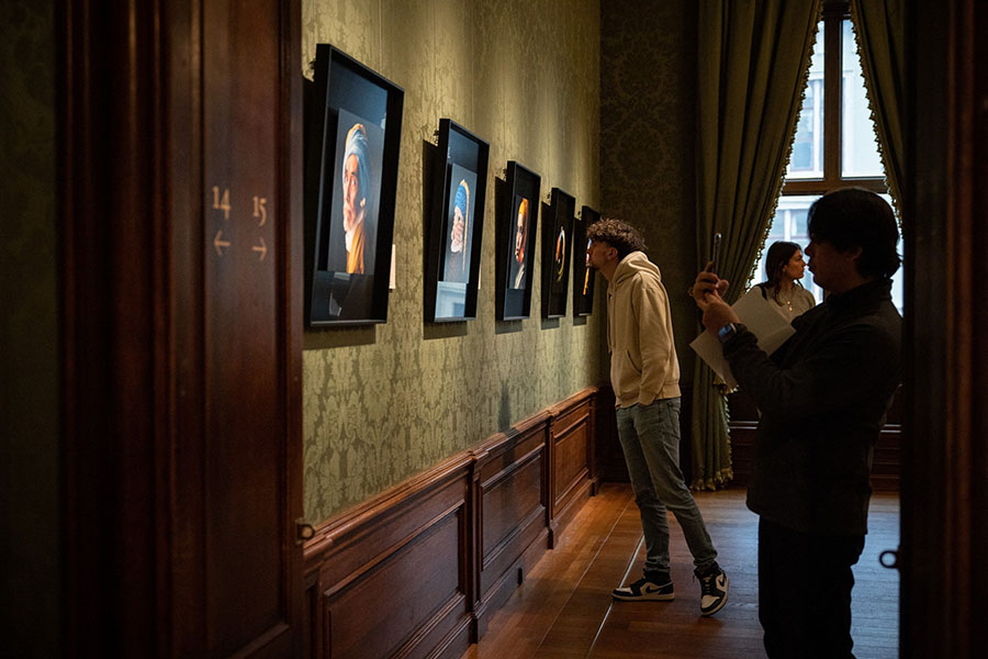 Visitors look at fans' recreations inspired by Johannes Vermeer's painting 