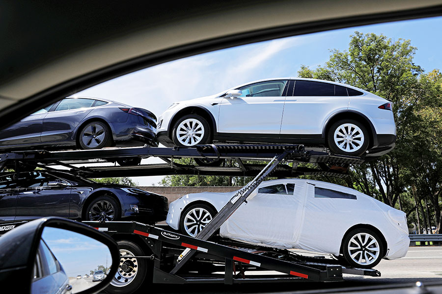 (File) Newly manufactured Tesla vehicles are transported along a freeway in Los Angeles, California, US, on August 24, 2018. Image: Reuters/Mike Blake