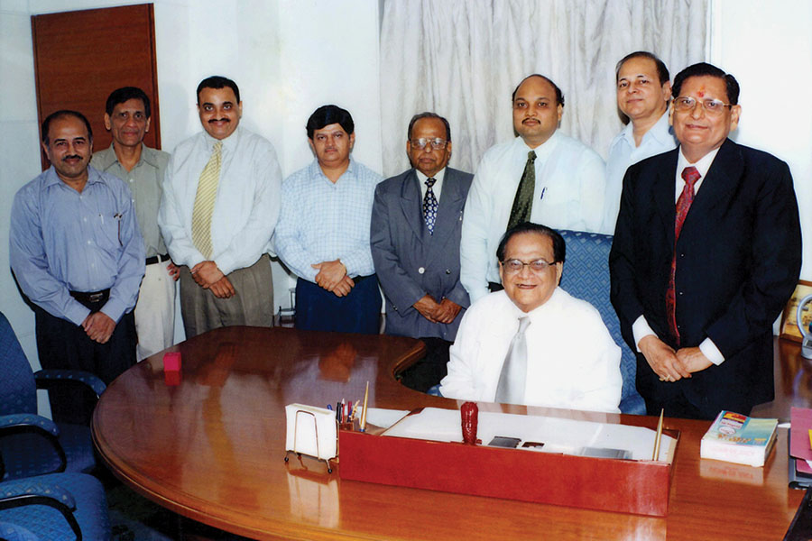 Late Samprada Singh (seated) and Basudeo Narayan Singh (standing on Samprada Singh’s right) with their core team in the initial days at the Alkem office