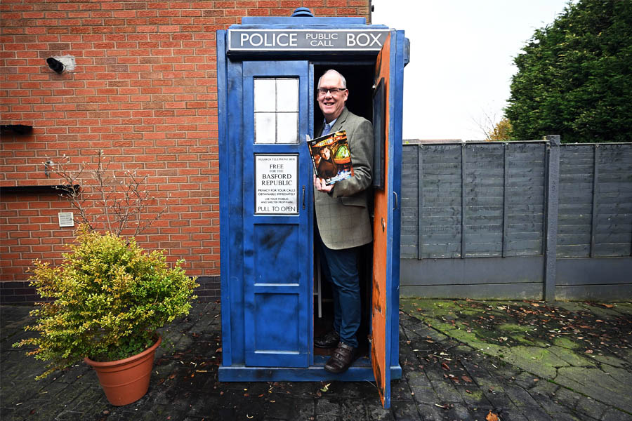Dr Who fan Tony Jordan poses for a photograph with his TARDIS in the garden of his home in Cannock, central England. Image: Paul Ellis / AFP©