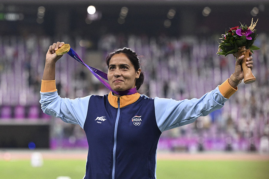 Gold medallist India's Parul Chaudhary celebrates on the podium during the medal ceremony for the women's 5,000m final athletics event during the 2022 Asian Games in Hangzhou in China's eastern Zhejiang province on October 3, 2023. Image: Hector Retmal / AFP 