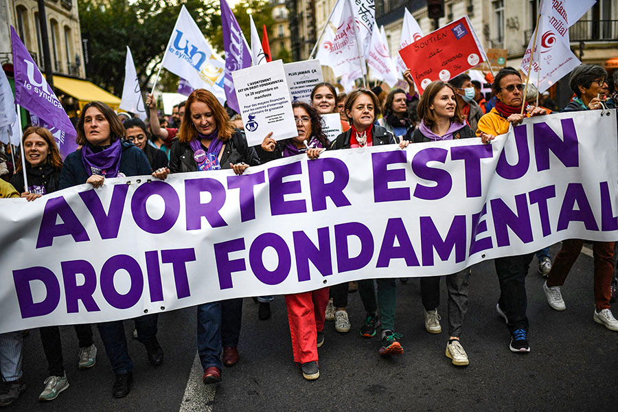 Demonstrators march behind a banner reading 'Abortion is a fundamental right' as they take part in an abortion rights rally on the annual International Safe Abortion Day in Paris on September 28, 2022. Image: Christophe ARCHAMBAULT / AFP