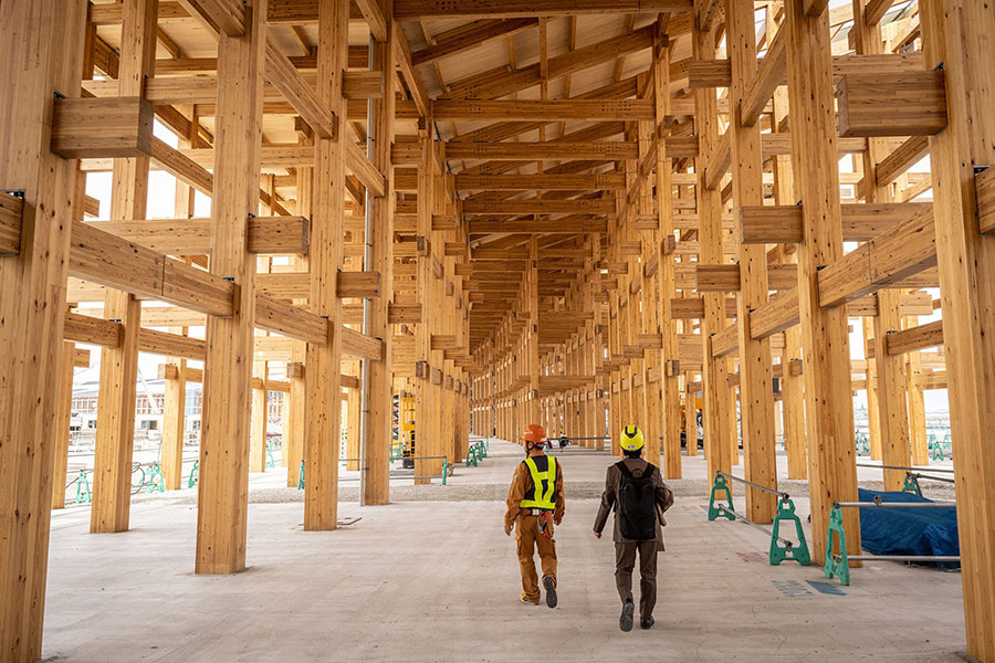 Workers walking under the construction of the 
