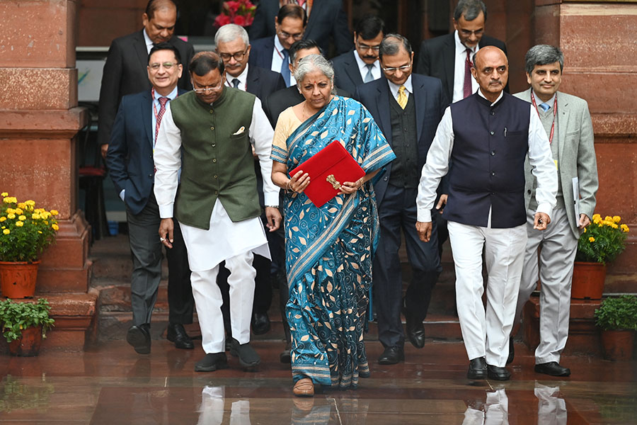 India's Finance Minister Nirmala Sitharaman (C) holds the briefcase containing the annual budget documents as she leaves the Finance ministry with her staff to present the budget in the parliament in New Delhi on February 1, 2024.
Image: Sajjad Hussain / AFP 