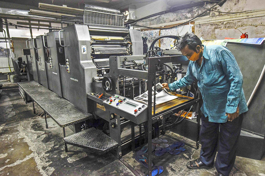 A man working on an offset printer at a printing unit at Okhla industrial area in New Delhi, India. Image: Biplov Bhuyan/Hindustan Times via Getty Images