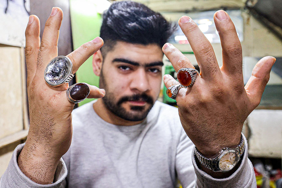 An Iranian man shows his stone rings at the old bazaar in the city of Shahr-e Ray (Rey), south of Tehran, Iran. Image: Photography ATTA KENARE / AFP