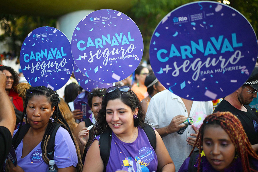 
Workers from Rio de Janeiro's City Hall promote a campaign for safer carnival for women during the parade of the street carnival group Loucura Suburbana.
Image: Mauro Pimentel / AFP©