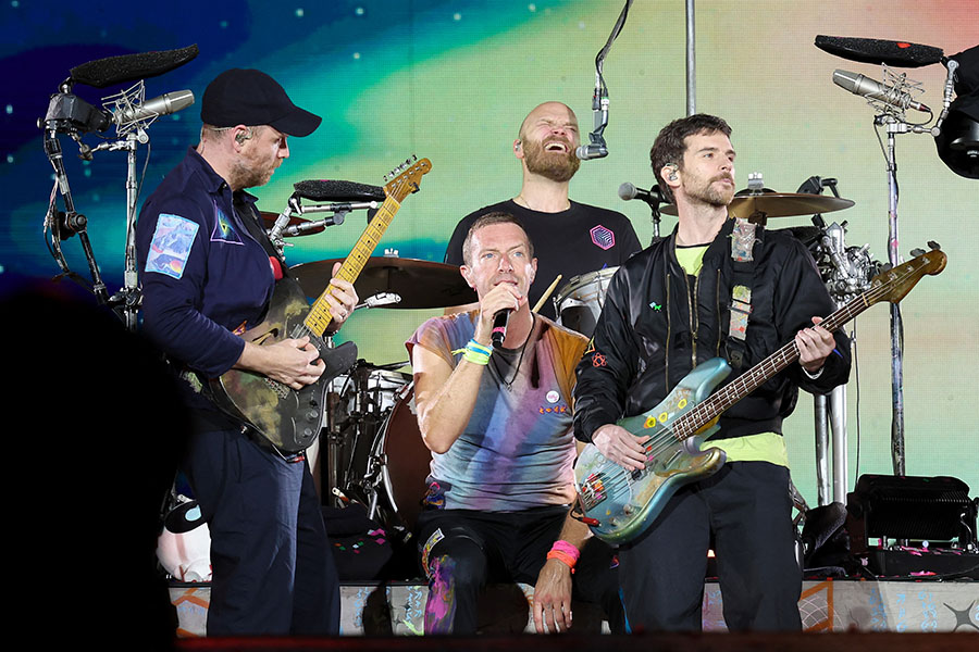 (L-R) Jonny Buckland, Chris Martin, Will Champion and Guy Berryman of Coldplay perform onstage at Rose Bowl Stadium on September 30, 2023 in Pasadena, California.    Image:  Monica Schipper / Getty Images North America / Getty Images via AFP