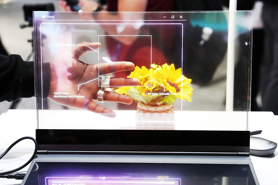 
A visitor tests the transparent display of new Lenovo ThinkBook laptop on the first day of the Mobile World Congress (MWC), the telecom industry's biggest annual gathering, in Barcelona. Image: Pau Barrena / AFP 