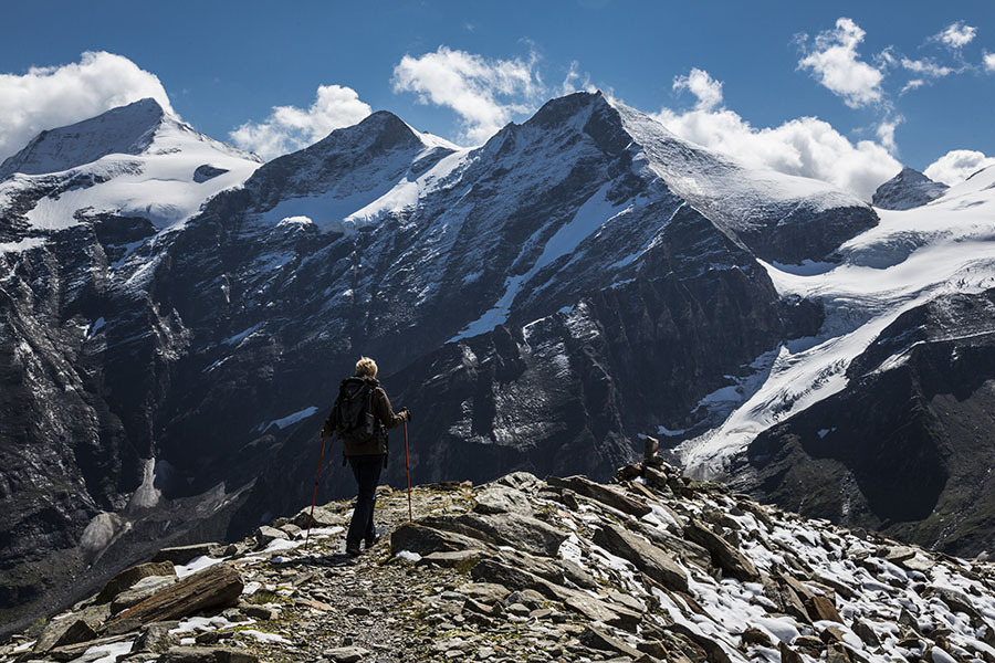 Young trekker on a hiking trail passing a snow-capped massif in the Australian, in Mooserboden, Austria. Photo: Thomas Trutschel/Photothek via Getty Images
