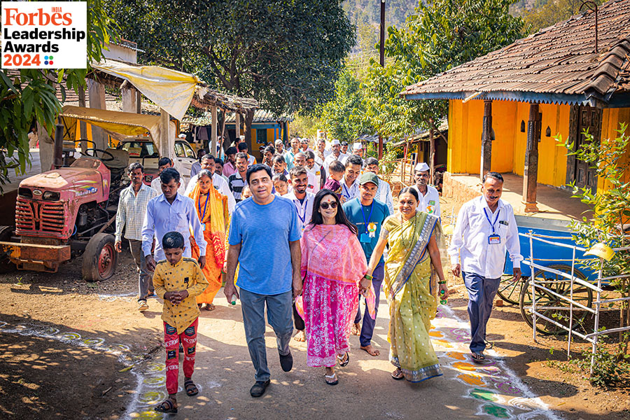 Ronnie (in T-shirt) and Zarina Screwvala (in pink kurta) visiting a village in Nashik where they work with the community
Image: Apoorva Salkade For Forbes India