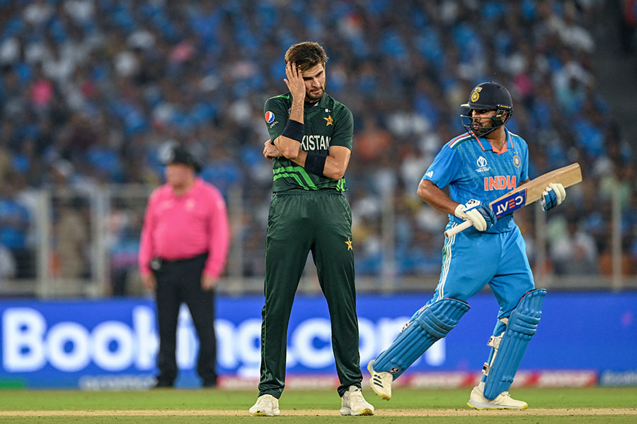 Pakistan's Shaheen Shah Afridi (L) gestures as India's captain Rohit Sharma runs between the wickets during the 2023 ICC Men's Cricket World Cup one-day international (ODI) match between India and Pakistan at the Narendra Modi Stadium in Ahmedabad on October 14, 2023. Image credit: Punit PARANJPE / AFP