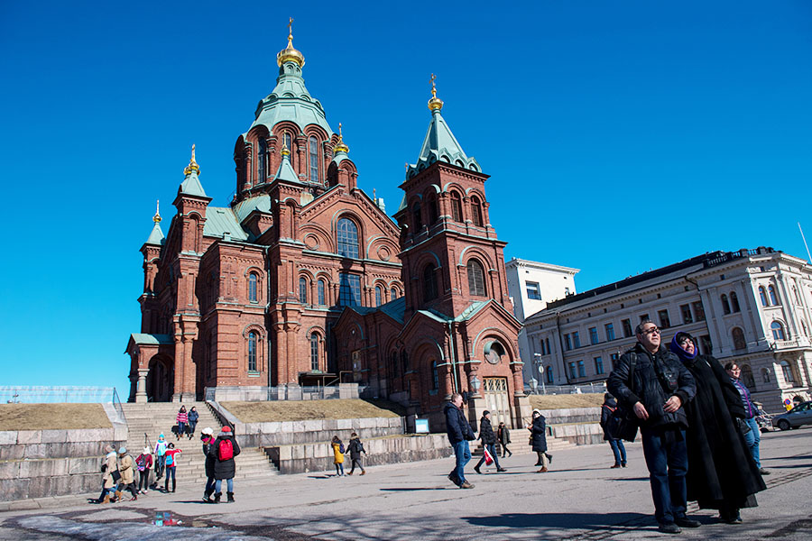 Tourists take photographs in front of Russian Orthodox Uspenski Cathedral on March 30, 2018 in Helsinki, Finland. Image credit: Chris J Ratcliffe/Getty Images