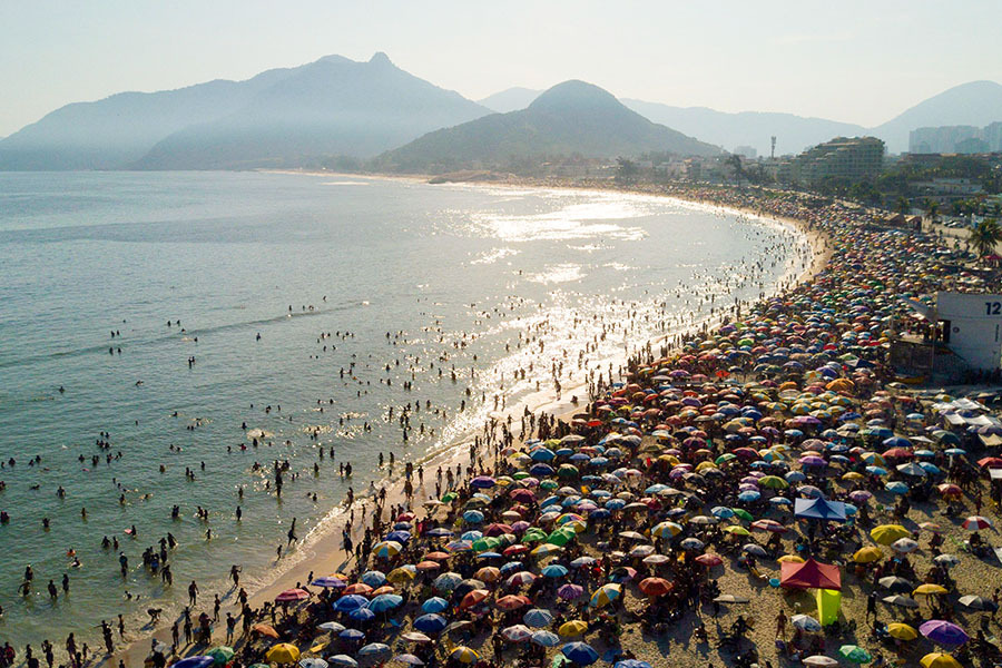 Aerial view of people enjoying Recreio dos Bandeirantes beach amid a heat wave in Rio de Janeiro, Brazil. Image: Photography TERCIO TEIXEIRA / AFP
